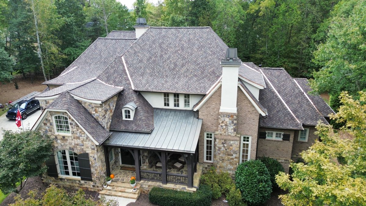 Front drone view of finished Presidential Shake roof with copper accents