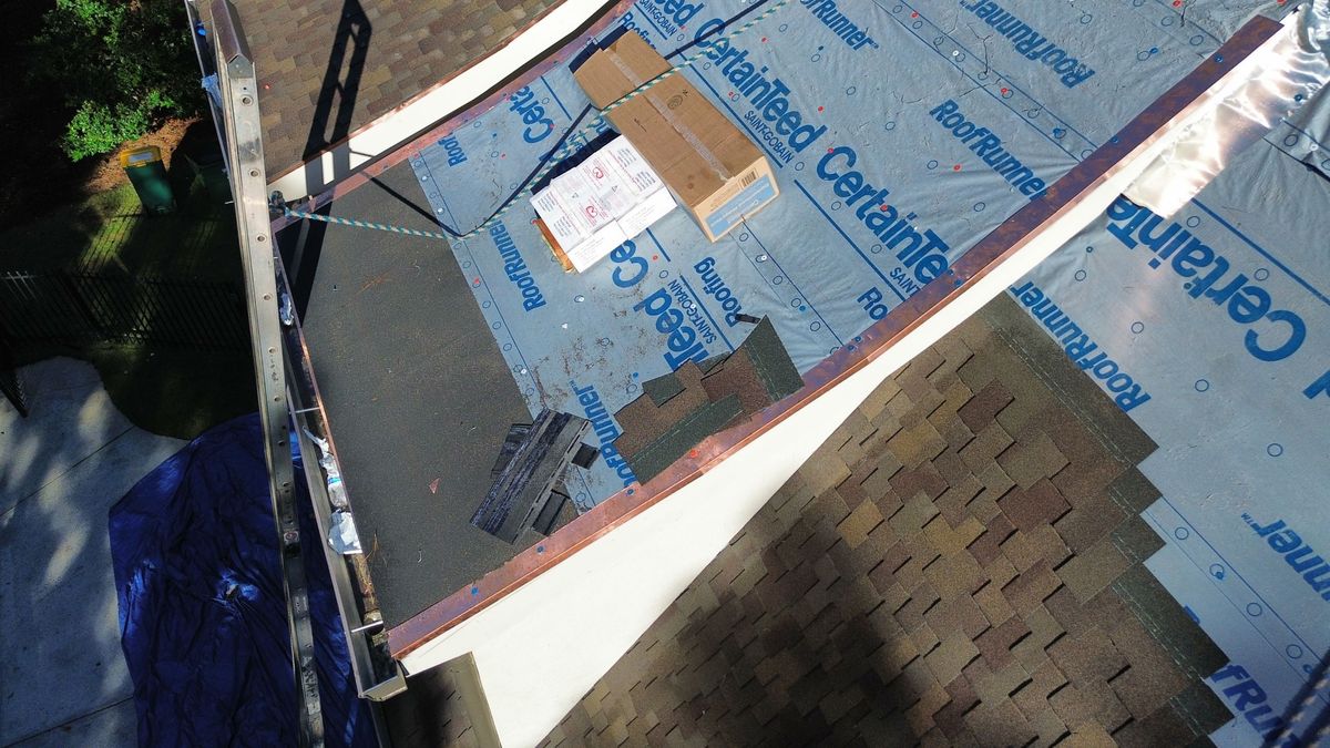 Custom copper drip edge installation on Presidential Shake roof