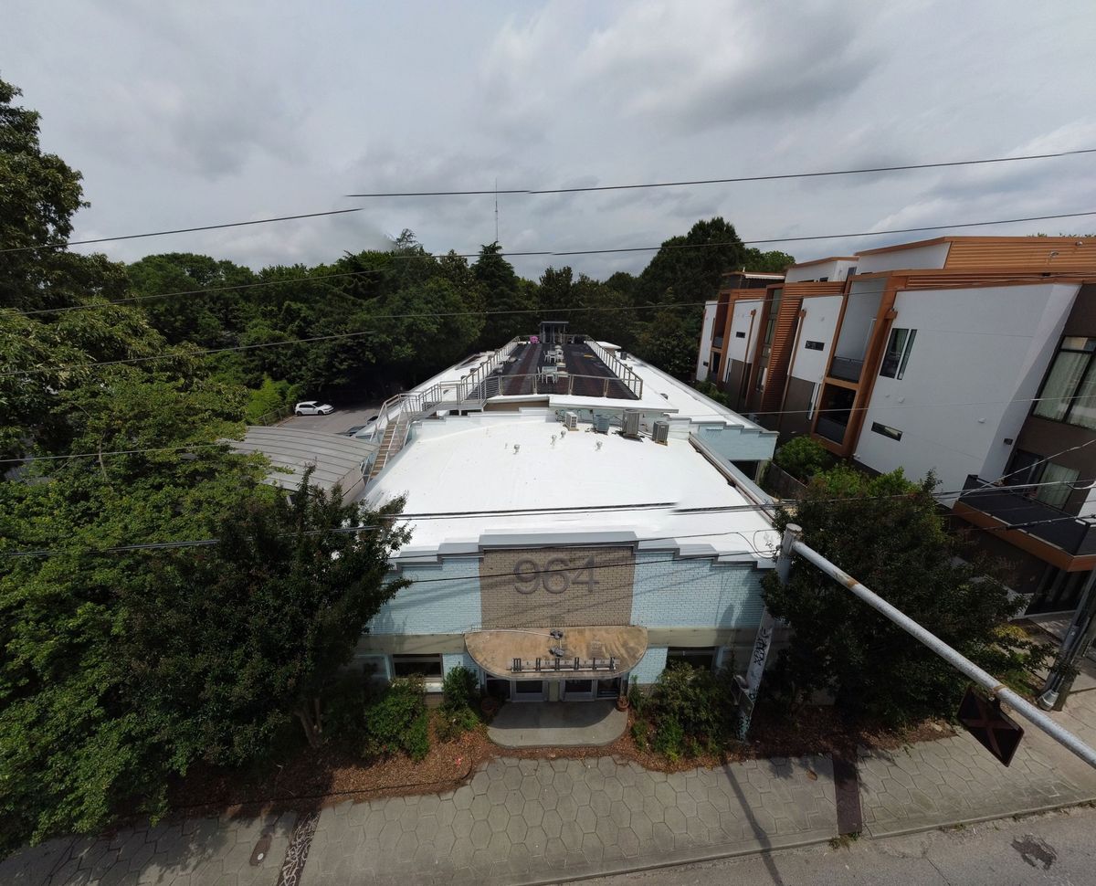 Commercial building with completed TPO roof and paver system — main drone overview