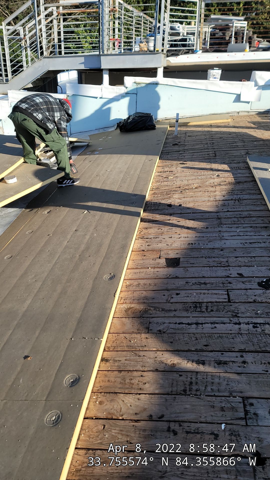 TPO membrane installation in progress on commercial roof — waterproofing layer visible