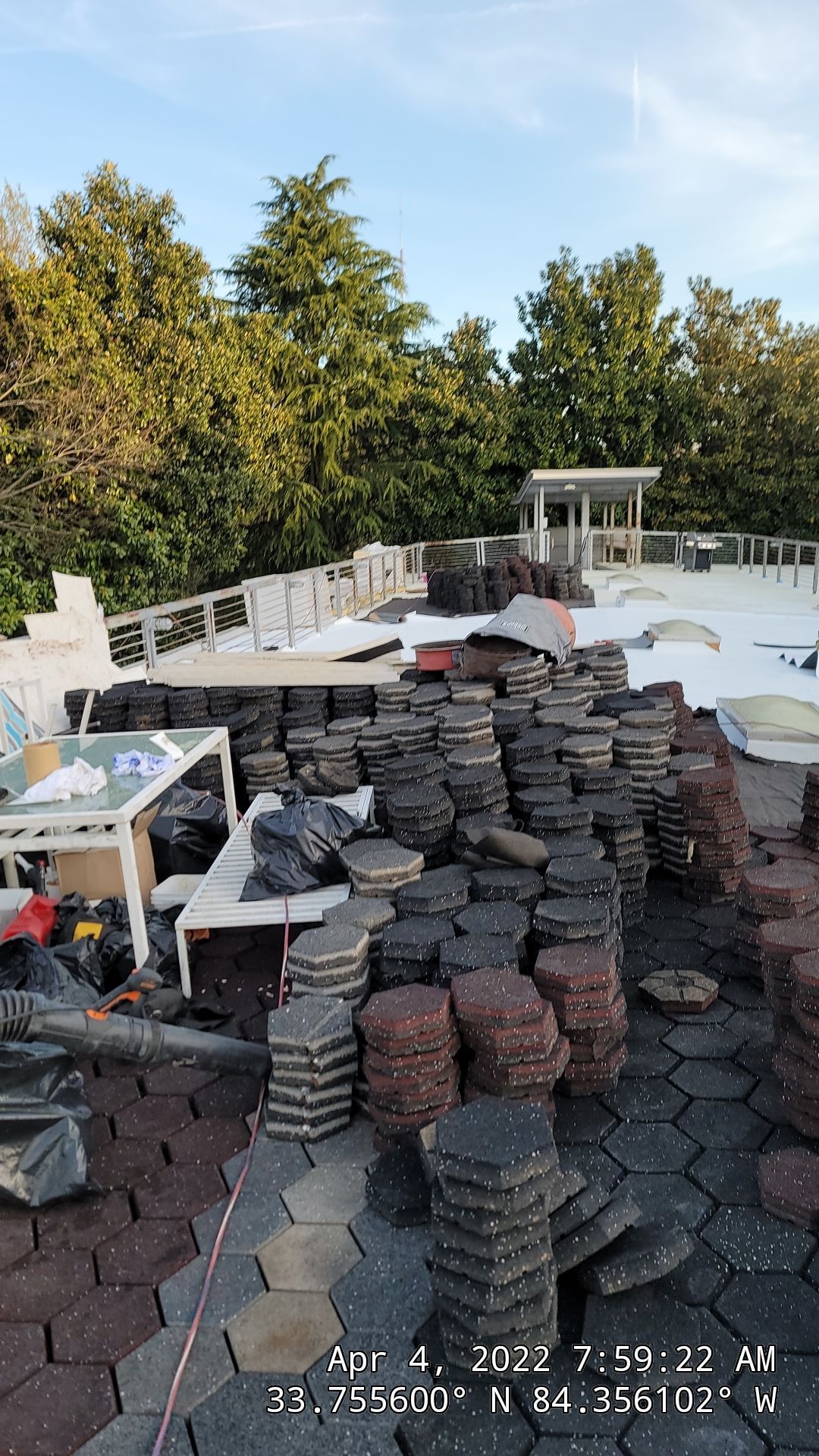Walkable paver system being positioned on commercial TPO roof