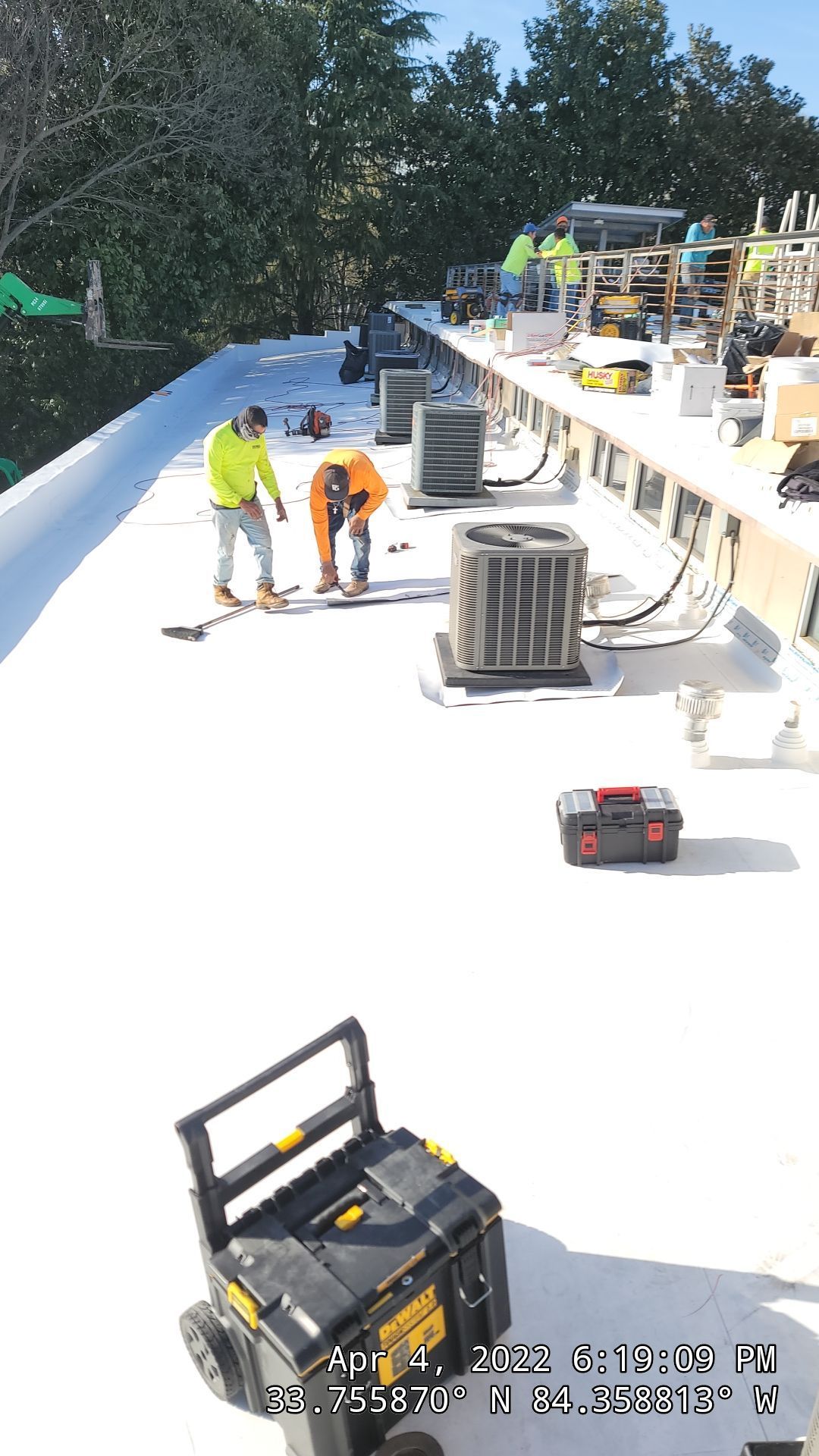 Commercial TPO roof with paver system — installation phase aerial documentation