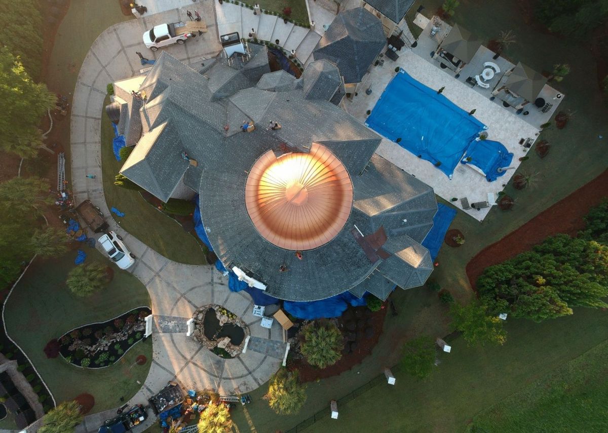 Wright aerial view of finished luxury estate roof with Mission Brown shingles and copper
