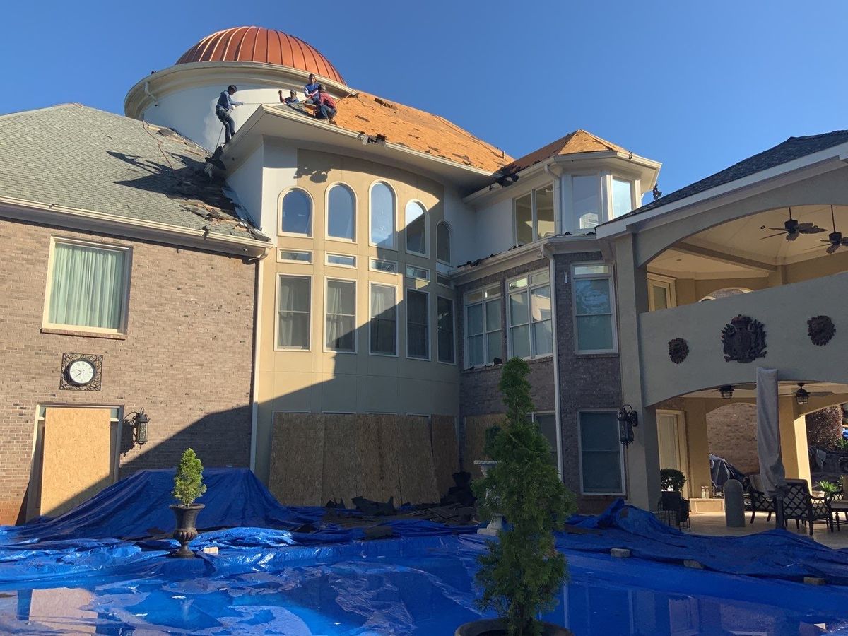 Custom copper gutter installation on luxury estate home