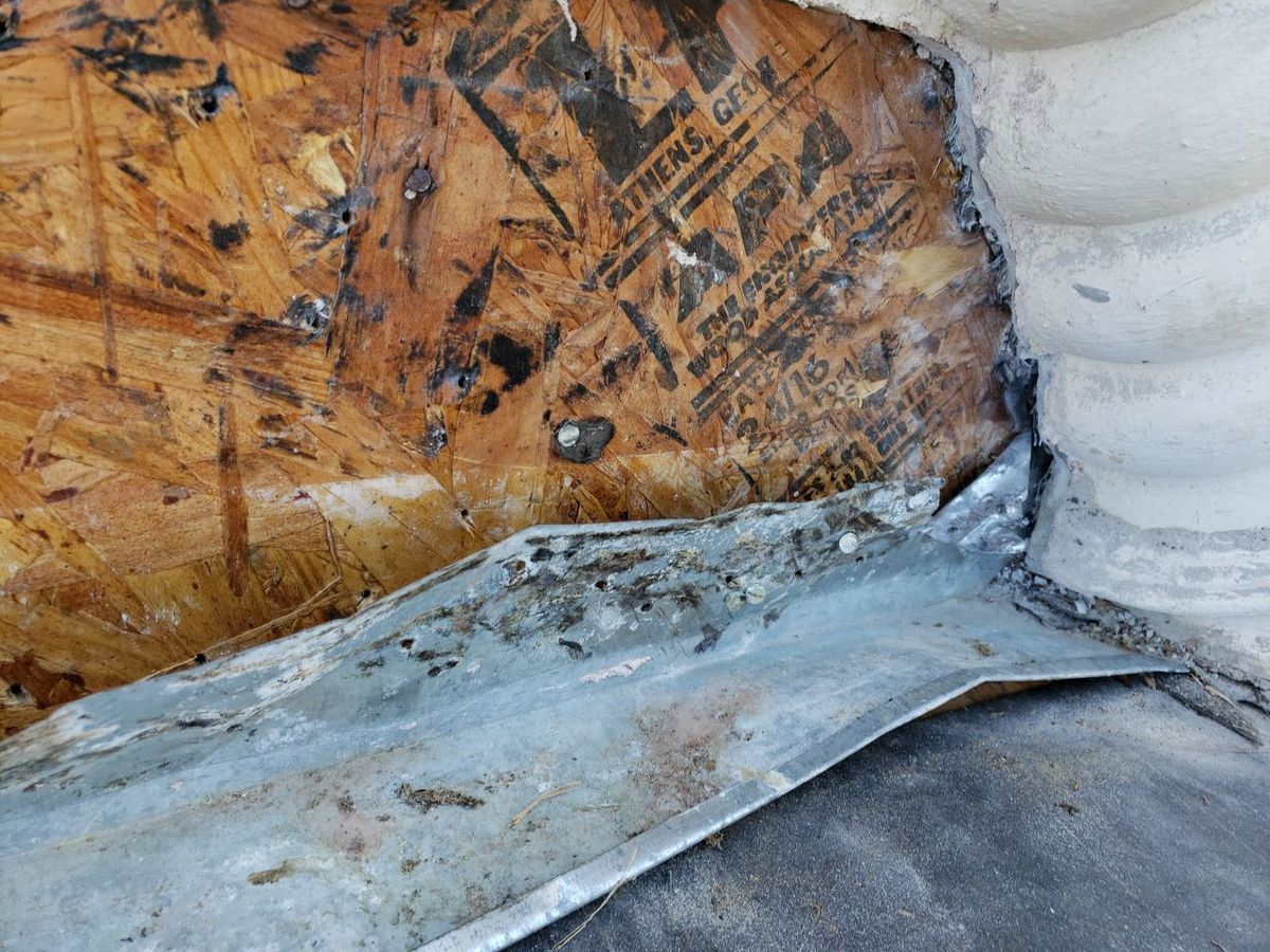 Stucco and roof interface — estate home during roof replacement