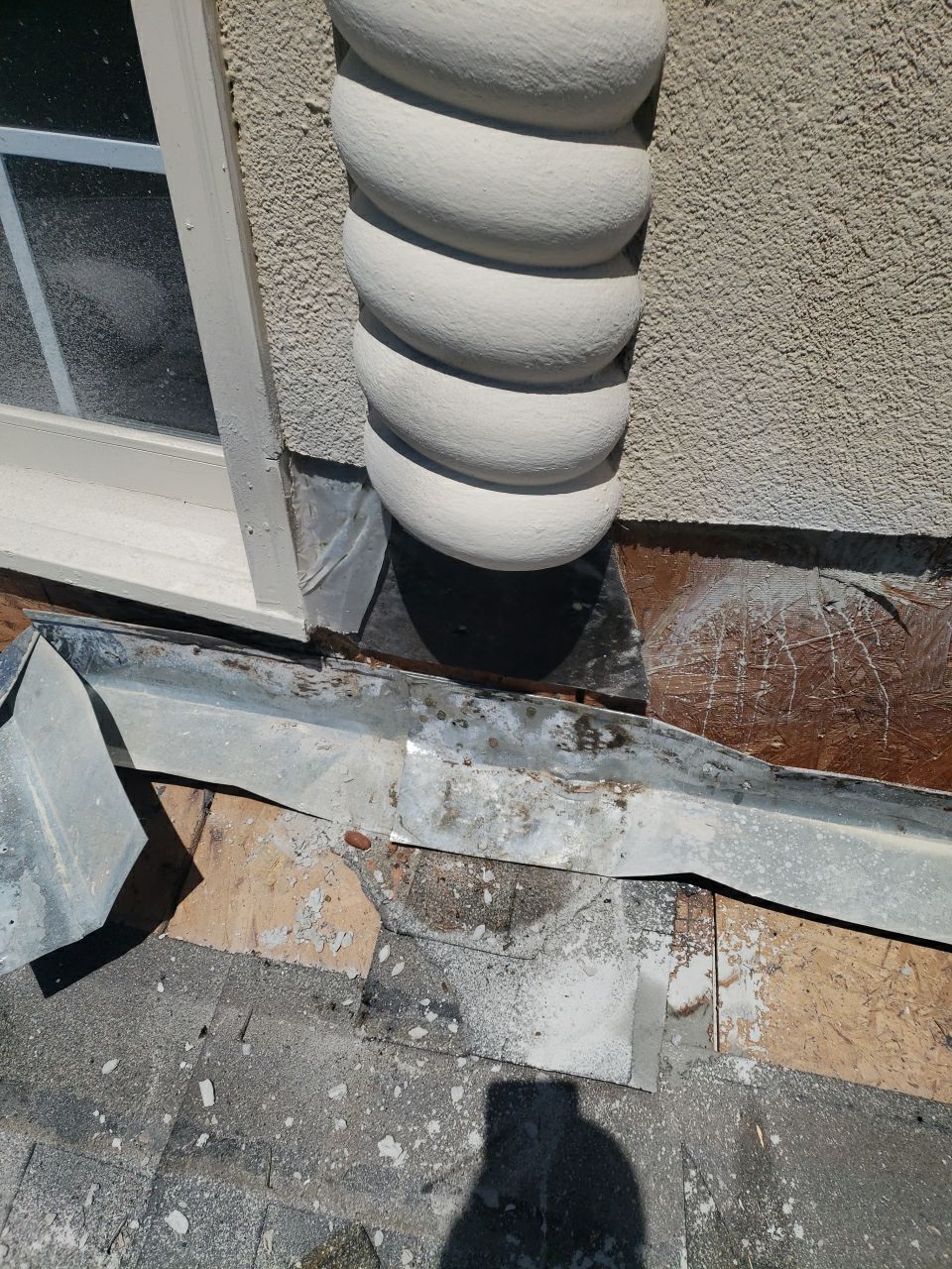 Stucco repair and sealing during estate roof project