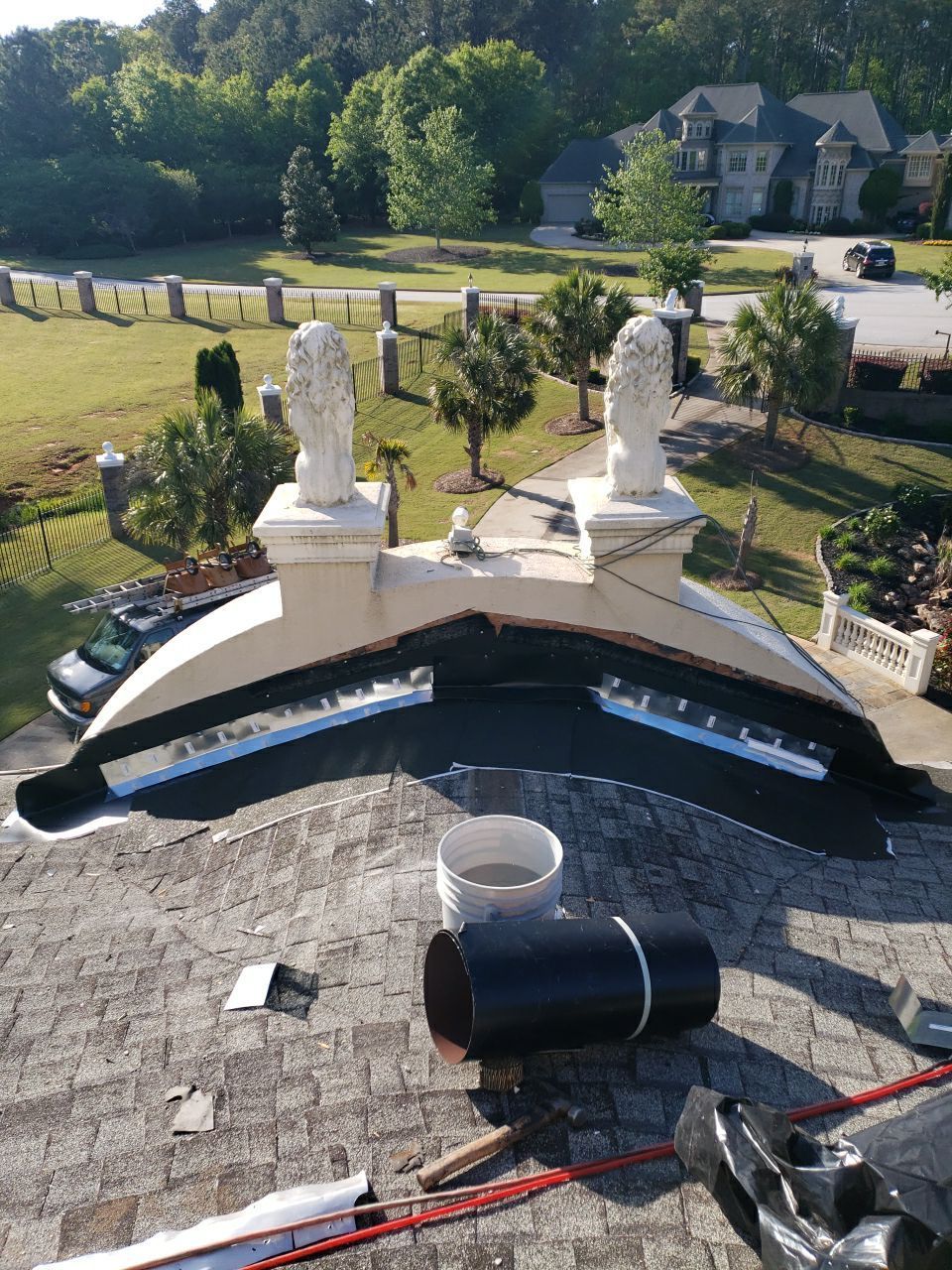 Final stucco detail work on estate home during comprehensive roof replacement