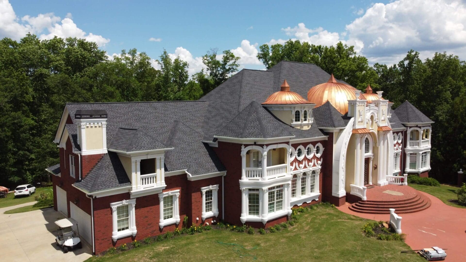 Large brick mansion with copper domes.